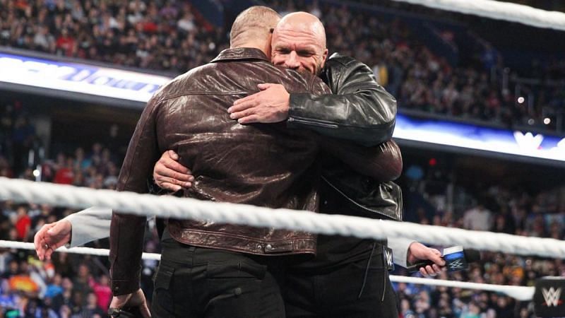 After a few tense moments, Batista and Triple H hug it out.