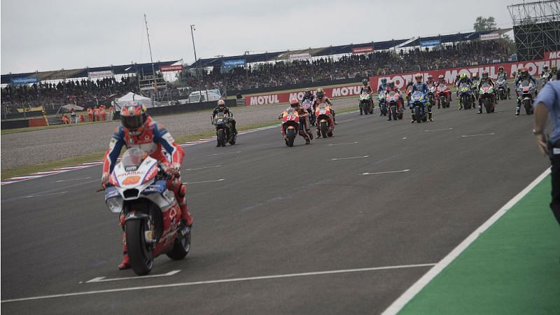 Marc Marquez attempts to restart his bike on the grid.
