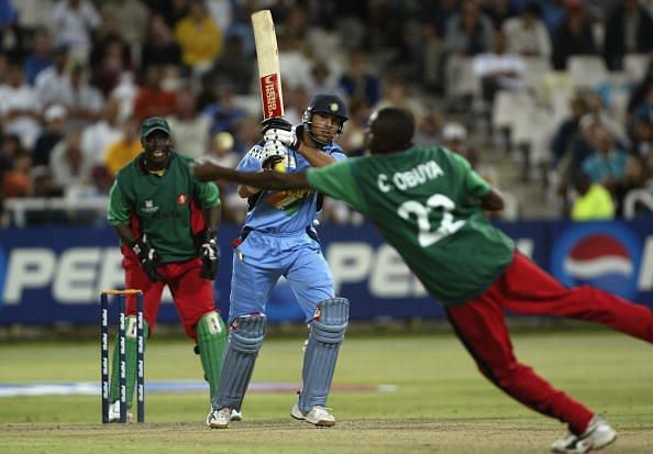 Yuvraj Singh of India drives the ball past Collins Obuya of Kenya