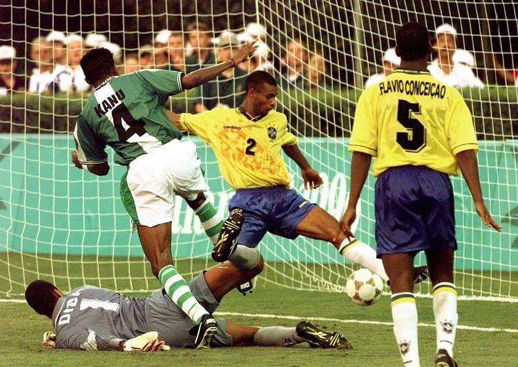 Kanu slots the ball past Dida to give Nigeria victory against Brazil