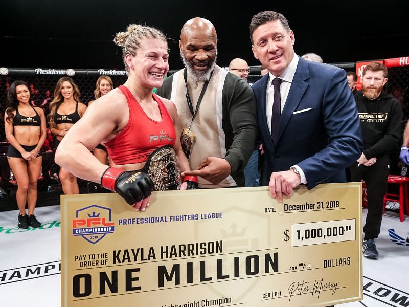 Mike Tyson handing the PFL 2019 Championship belt to Kayla Harrison 