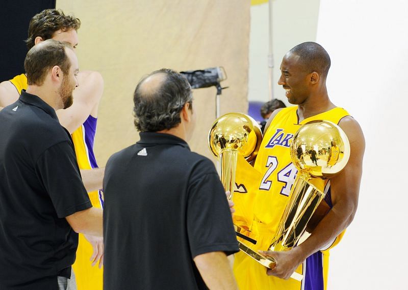 Kobe Bryant #24 of the Los Angeles Lakers reacts after receiving two NBA Finals Larry O&#039;Brien Championship Trophy&#039;s from Lakers photographers.