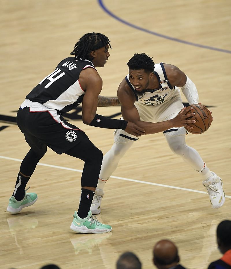 Donovan Mitchell (#45) of the Utah Jazz is defended by Terance Mann (#14) of the LA Clippers