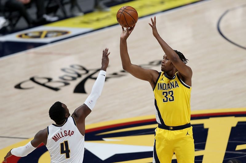 Myles Turner (right) shoots the ball over Paul Millsap of the Denver Nuggets.