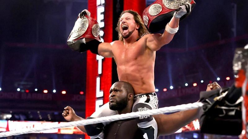 Omos (7ft 2in) celebrating with AJ Styles (5ft 9in)