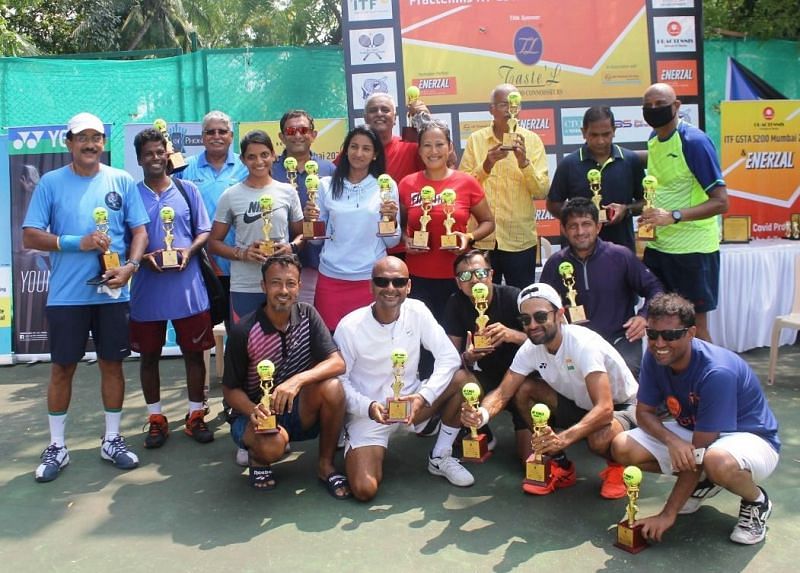 Proud winners of singles and doubles pose with their trophies at the Taste&#039;L $ 200 ITF Mumbai on Friday