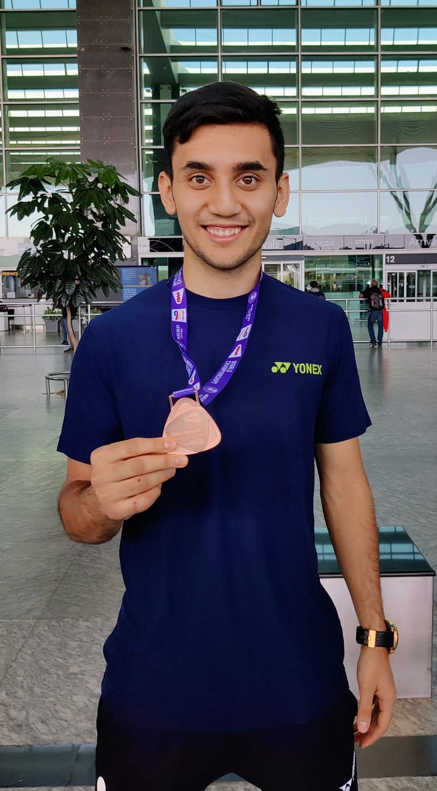 Lakshya Sen flashes his World Championships bronze medal at the Bengaluru Airport on Tuesday. (Image courtesy: DK Sen)
