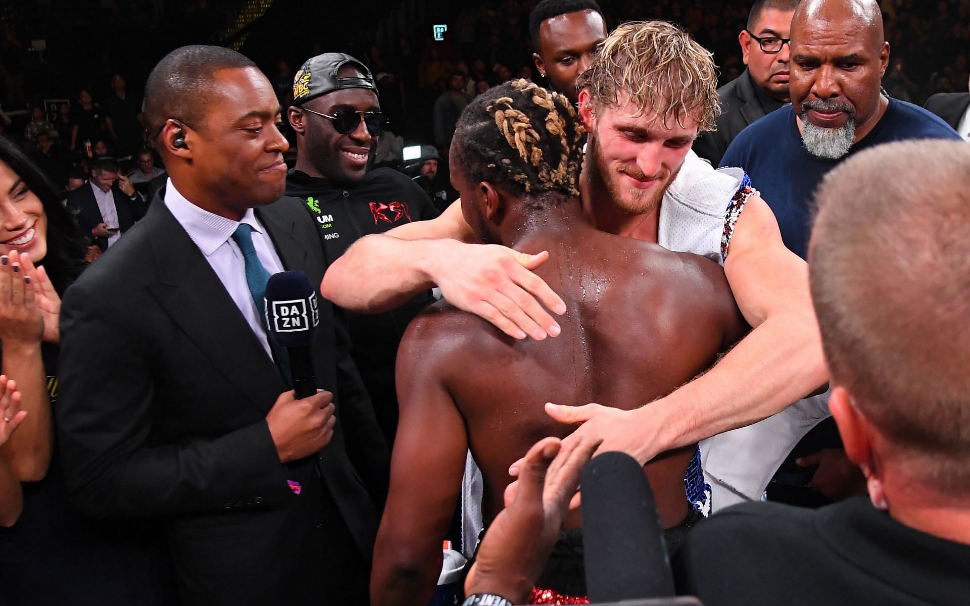 KSI and Logan Paul (center) hug in the ring after their debut professional boxing fight on November 9, 2019, in California