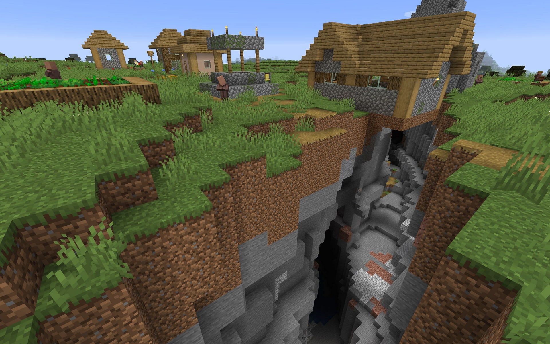 A ravine running below a village (Image via Minecraft Seed HQ)