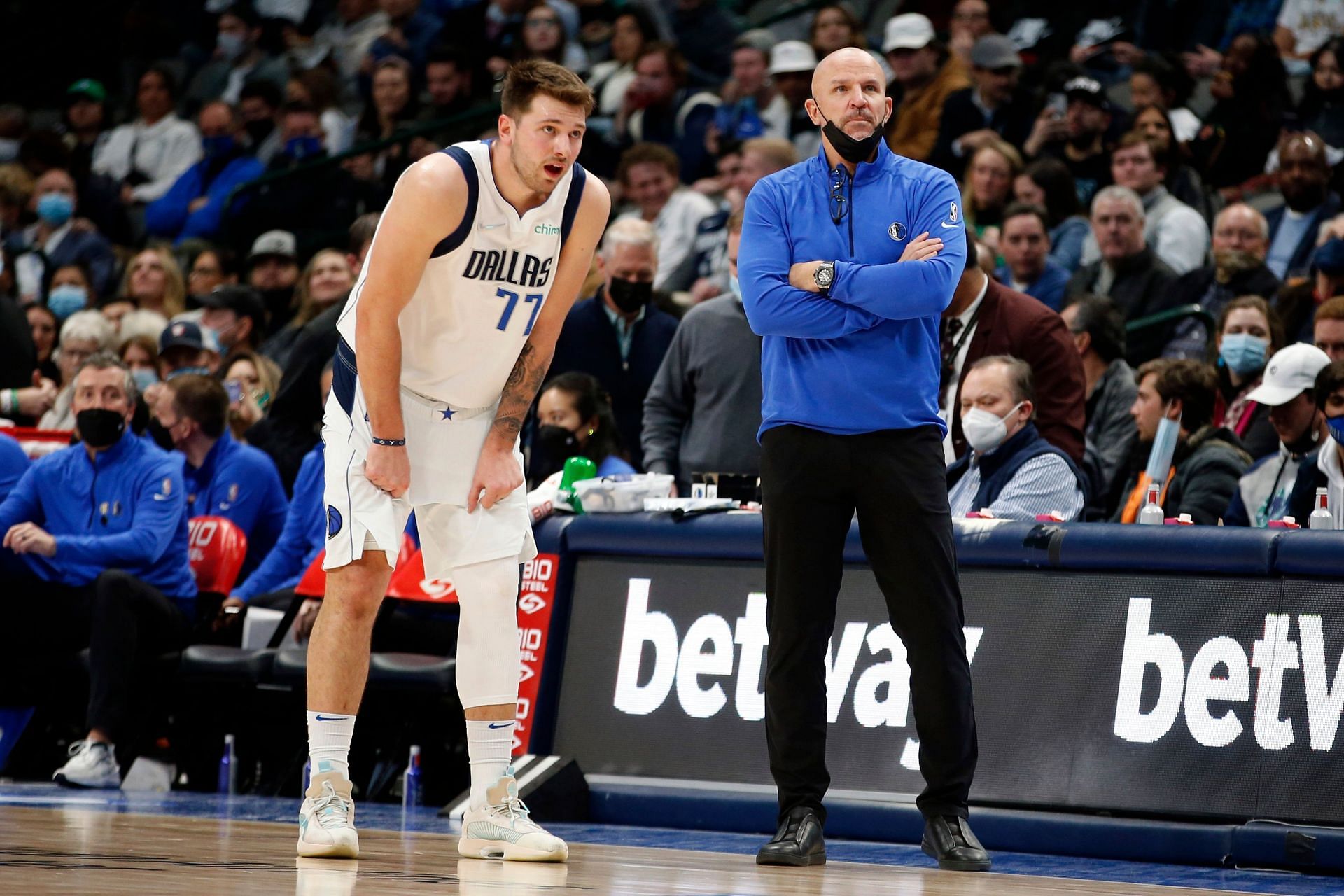 Luka Doncic and Jason Kidd watch on during a game.