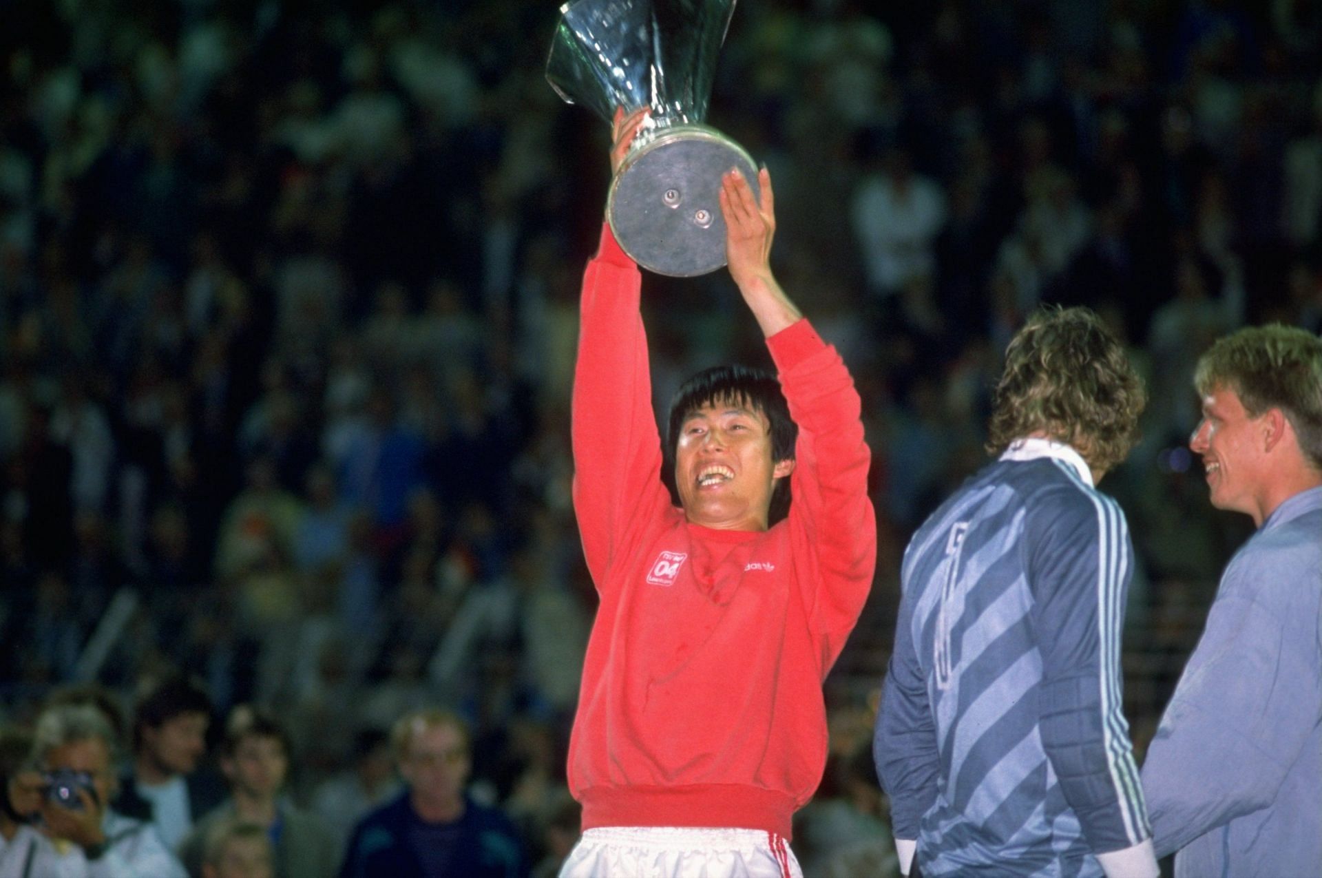 Cha-Bum-Kun of Bayer Leverkusen holds the trophy up in victory after the UEFA Cup Final