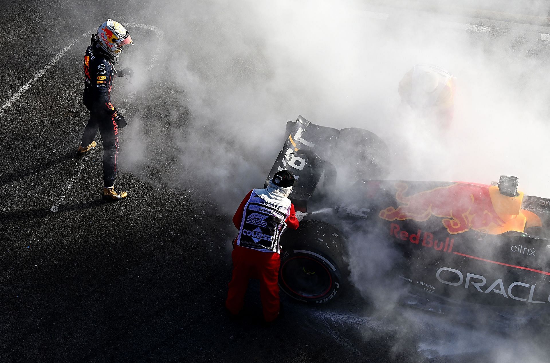 Max Verstappen tends to the fire in his car after retiring from the F1 Grand Prix of Australia (Photo by Clive Mason/Getty Images)