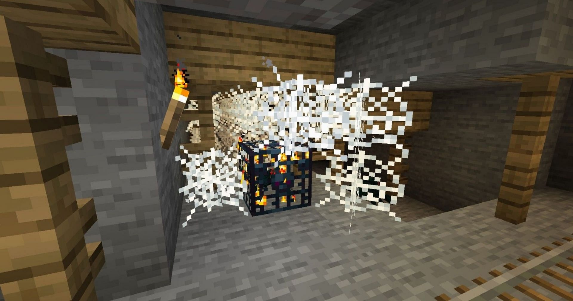 Spawners in mineshafts are almost always covered in cobwebs (Image via Mojang)