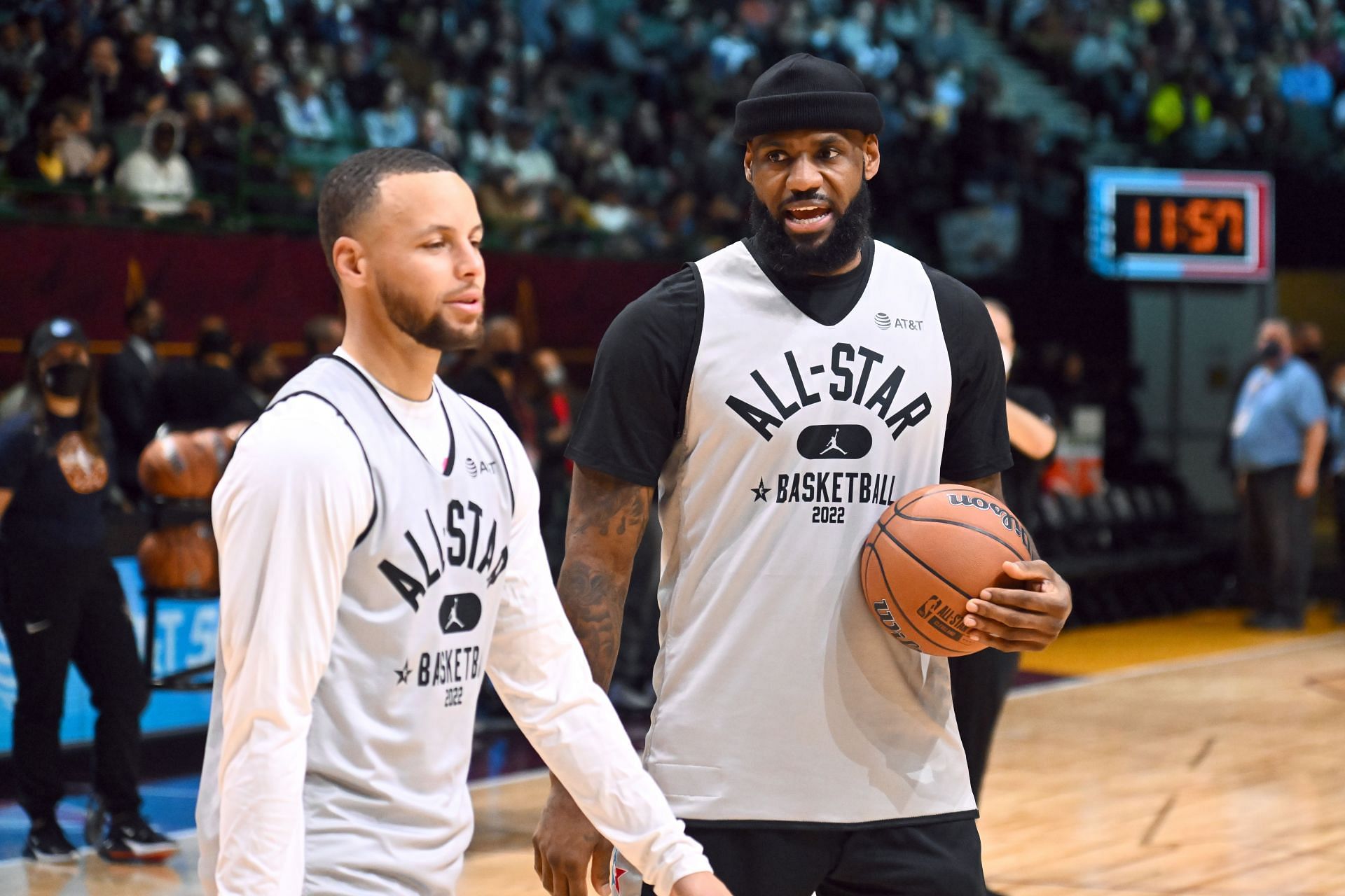 LeBron James (R) talks with Stephen Curry (L) of Team LeBron during the NBA All-Star practice