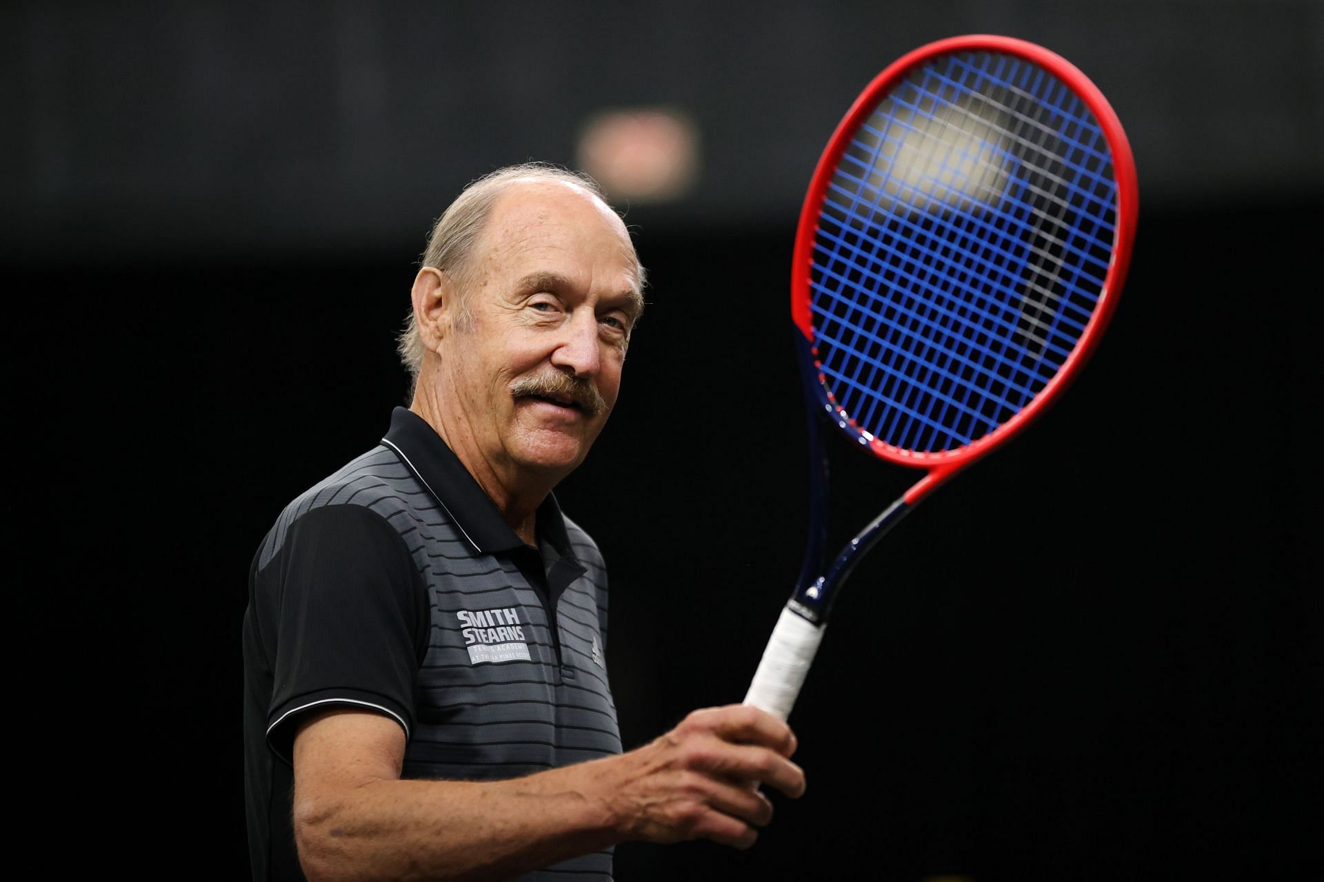 Stan Smith poses with a tennis racket