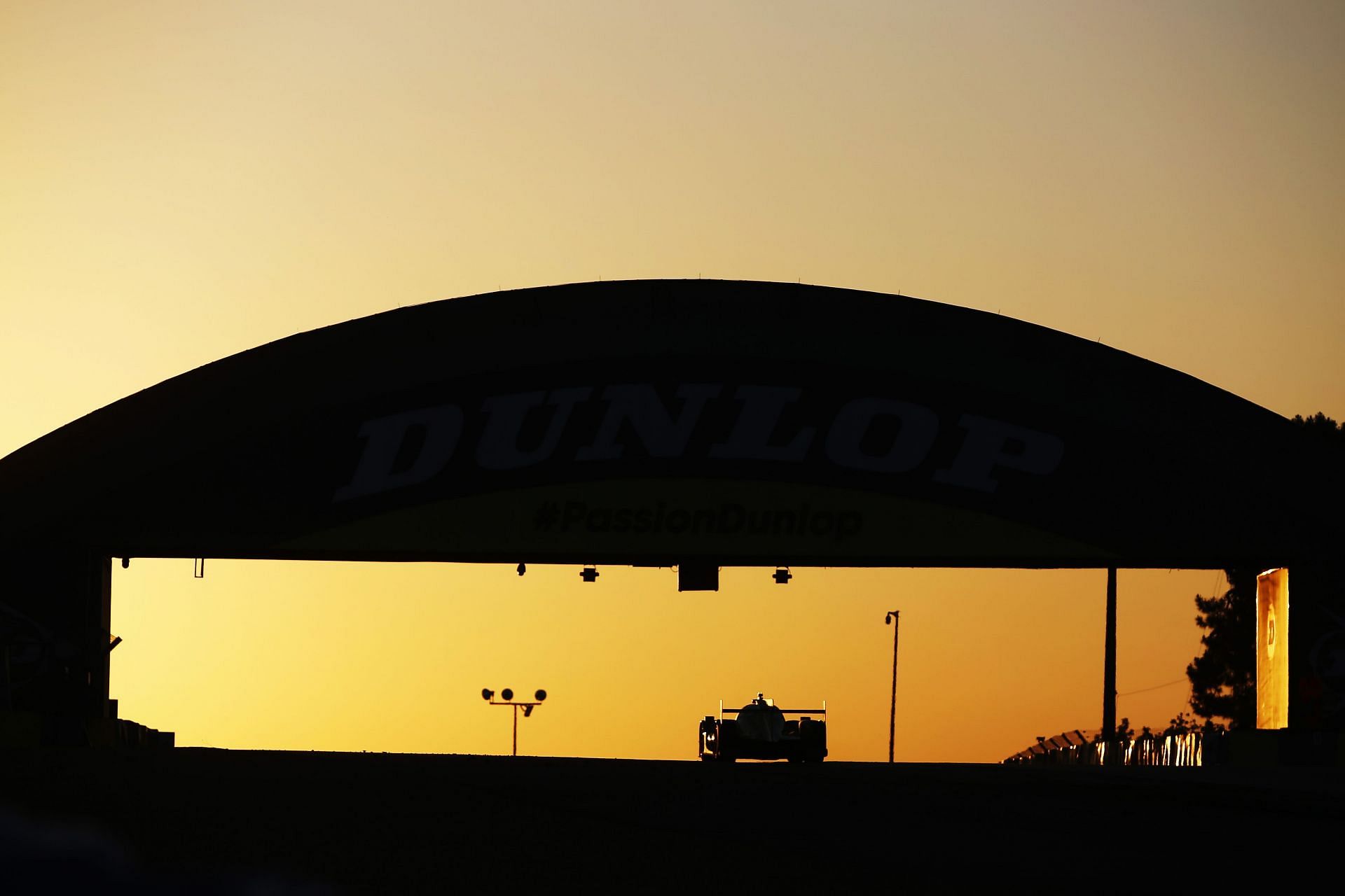 The #34 Inter Europol Competition Oreca 07 drives under the Dunlop Bridge at sunrise during the 24 Hours of Le Mans at the Circuit de la Sarthe in Le Mans, France (Photo by Ker Robertson/Getty Images)