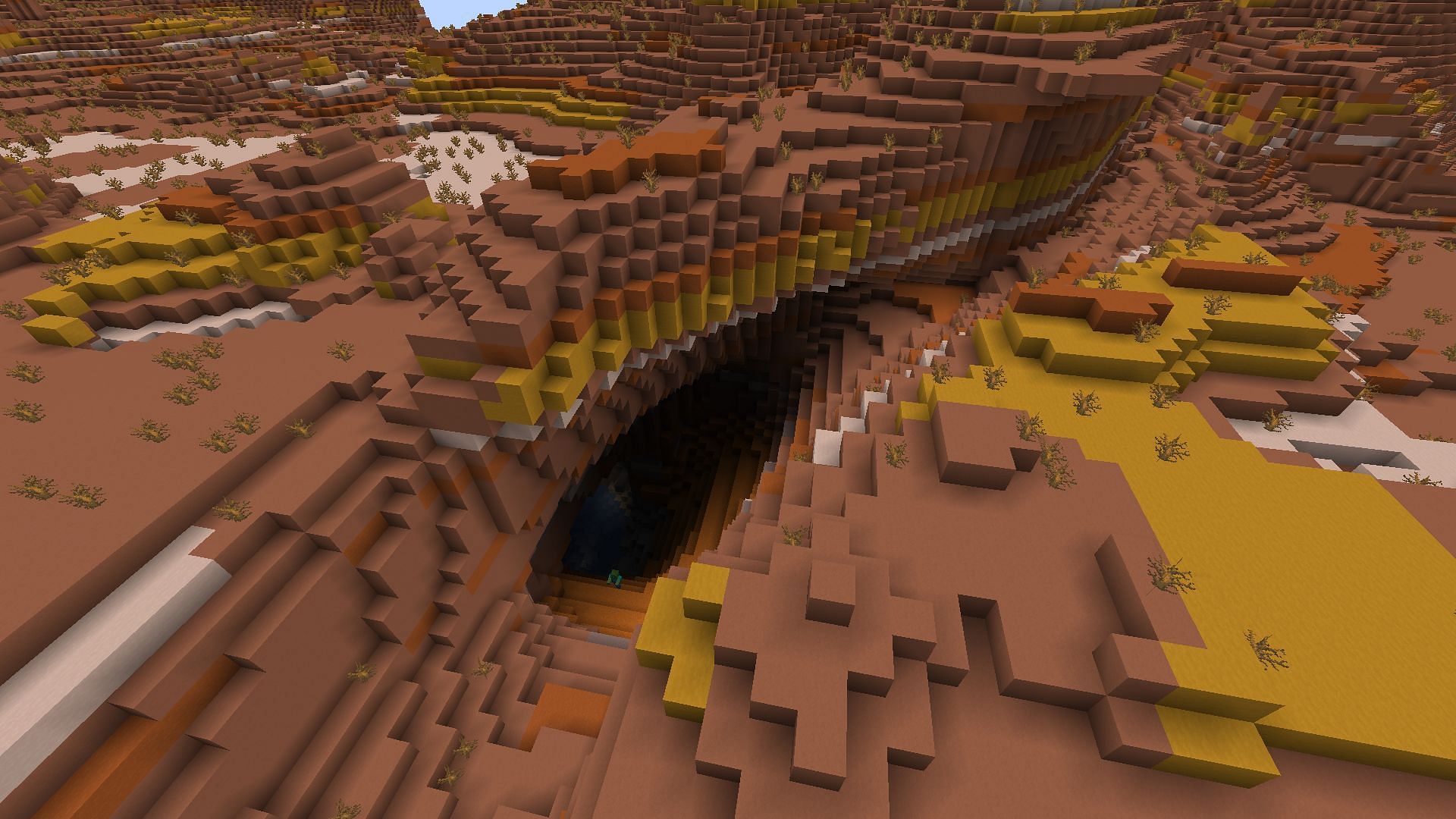 An example of a ravine in a badlands biome (Image via Minecraft)