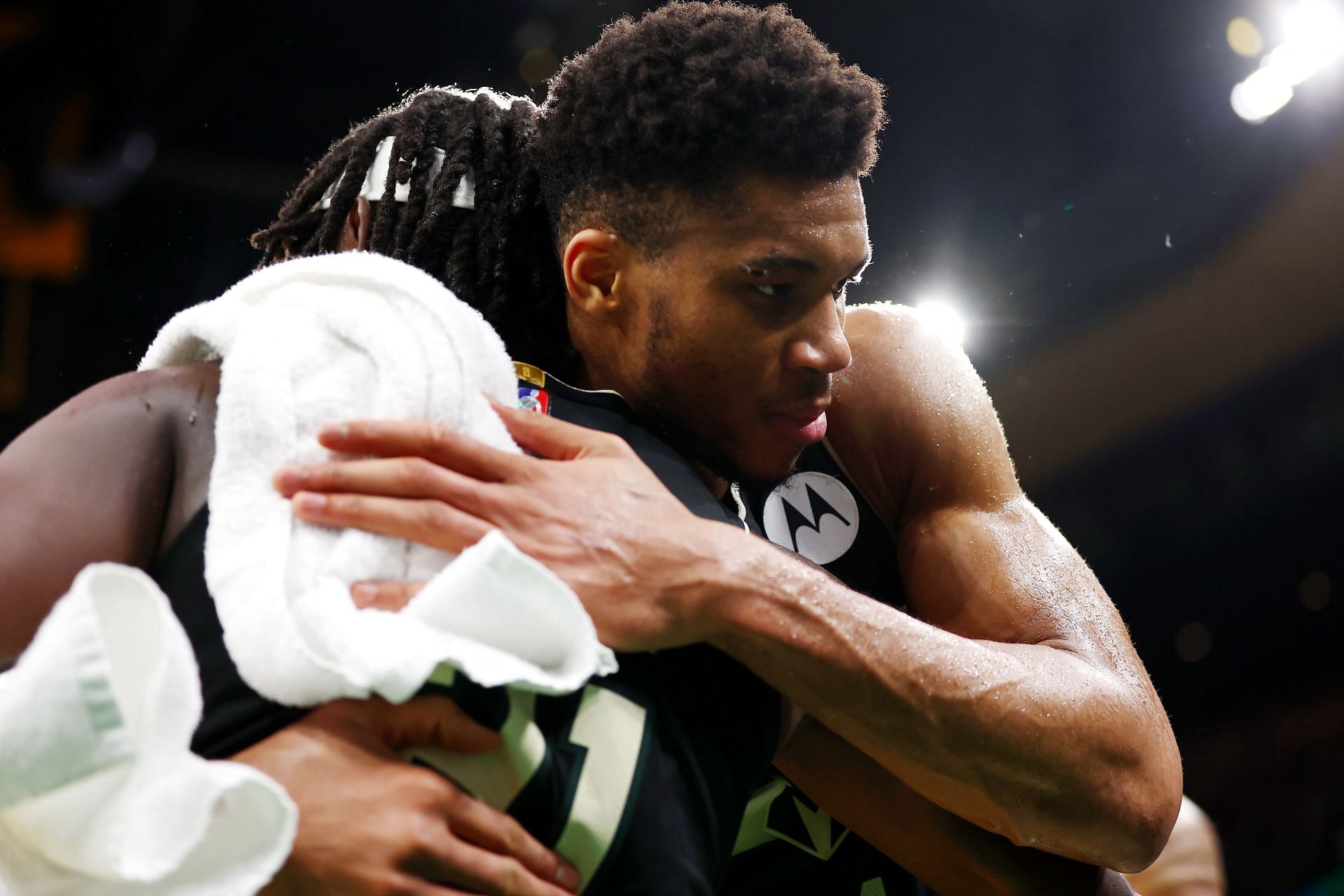Giannis Antetokounmpo #34 hugs Jrue Holiday #21 of the Milwaukee Bucks after being defeated by the Boston Celtics 109-81 in Game Seven of the 2022 NBA Playoffs Eastern Conference Semifinals at TD Garden on May 15, 2022 in Boston, Massachusetts