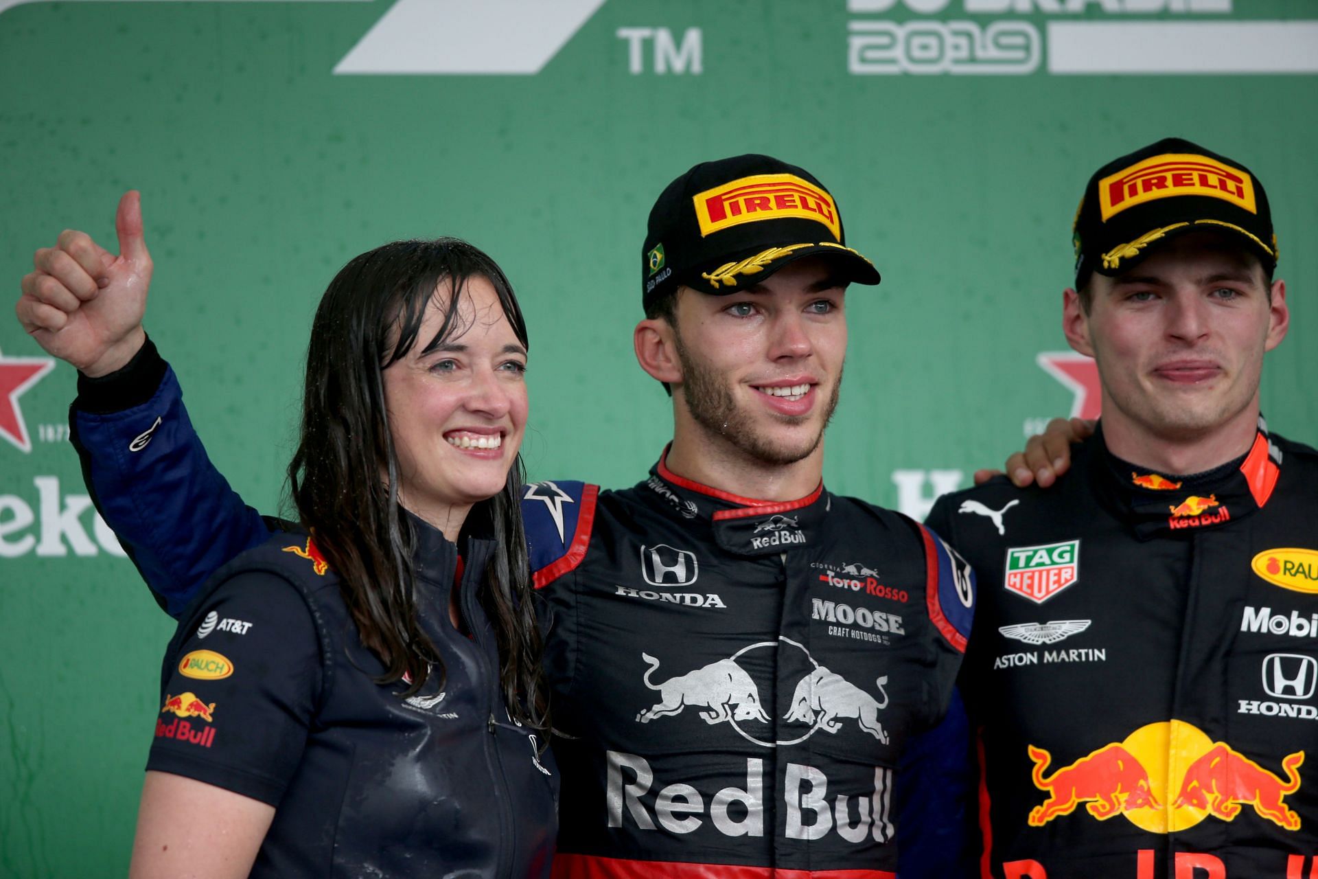 Hannah Schmitz celebrates with race winner Max Verstappen (R) and second-placed Pierre Gasly (C) on the podium during the F1 Grand Prix of Brazil at Autodromo Jose Carlos Pace on November 17, 2019, in Sao Paulo, Brazil (Photo by Charles Coates/Getty Images)