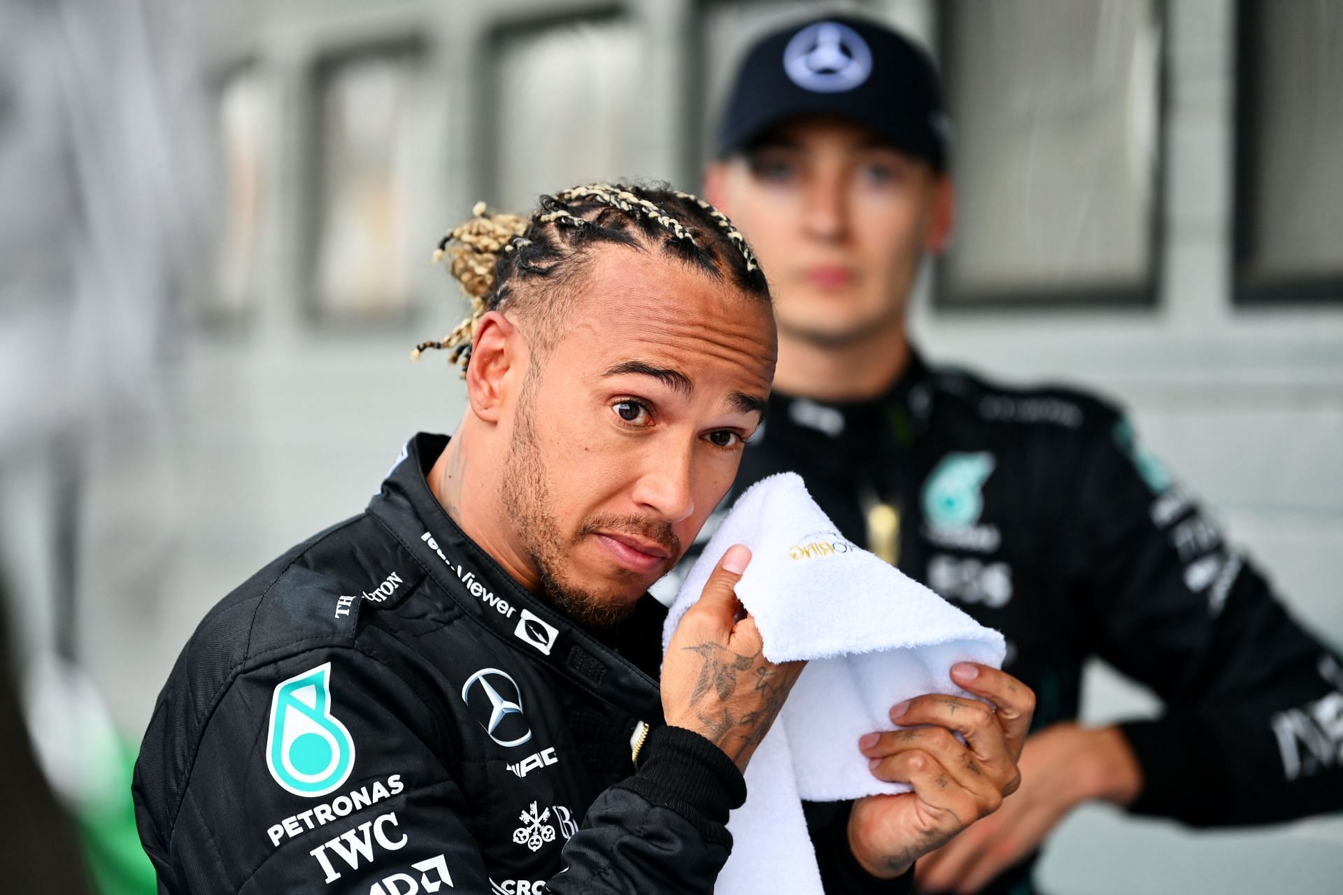 Lewis Hamilton and George Russell look on in parc ferme during the F1 Grand Prix of Hungary at Hungaroring on July 31, 2022, in Budapest, Hungary (Photo by Dan Mullan/Getty Images)