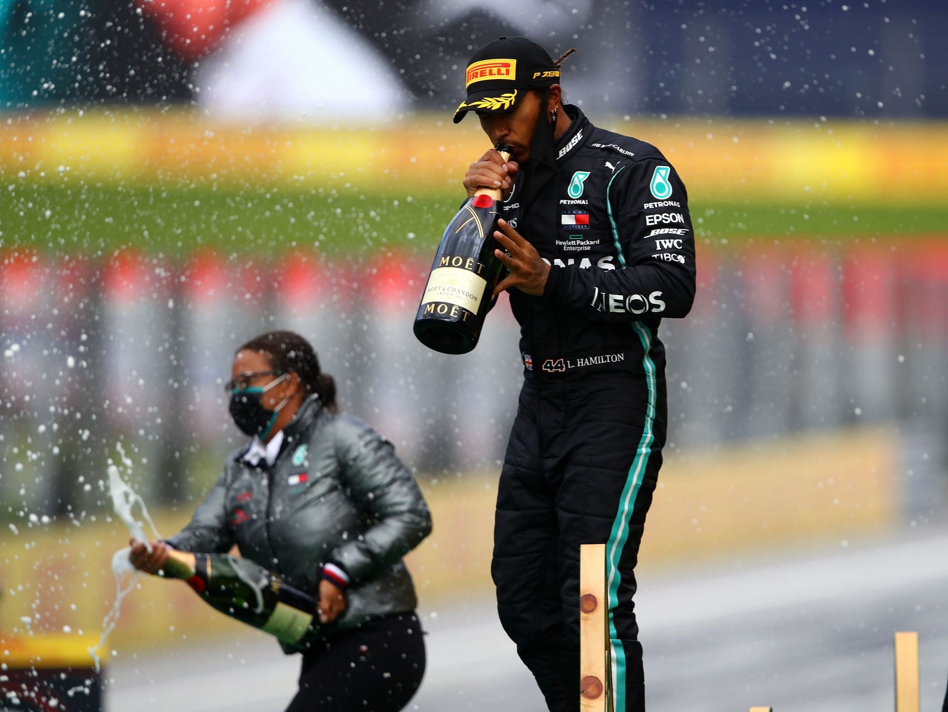 Stephanie Travers and Lewis Hamilton celebrate on the podium after winning the Formula One Grand Prix of Styria at Red Bull Ring on July 12, 2020, in Spielberg, Austria (Photo by Bryn Lennon/Getty Images)