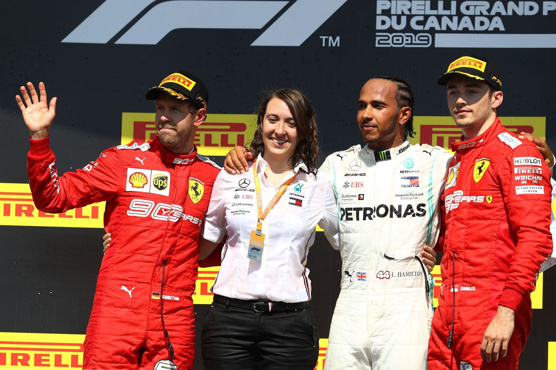 Margarita Torres Diez celebrates with Lewis Hamilton (C), Sebastian Vettel (L), and Charles Leclerc (R) on the podium during the F1 Grand Prix of Canada at Circuit Gilles Villeneuve on June 09, 2019, in Montreal, Canada (Photo by Mark Thompson/Getty Images)