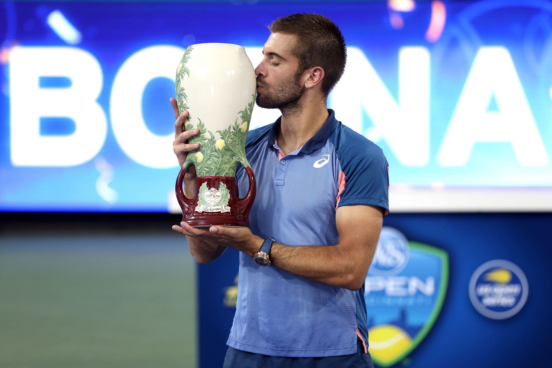 Newly minted Cincinnati Open champion Borna Coric kisses his trophy.