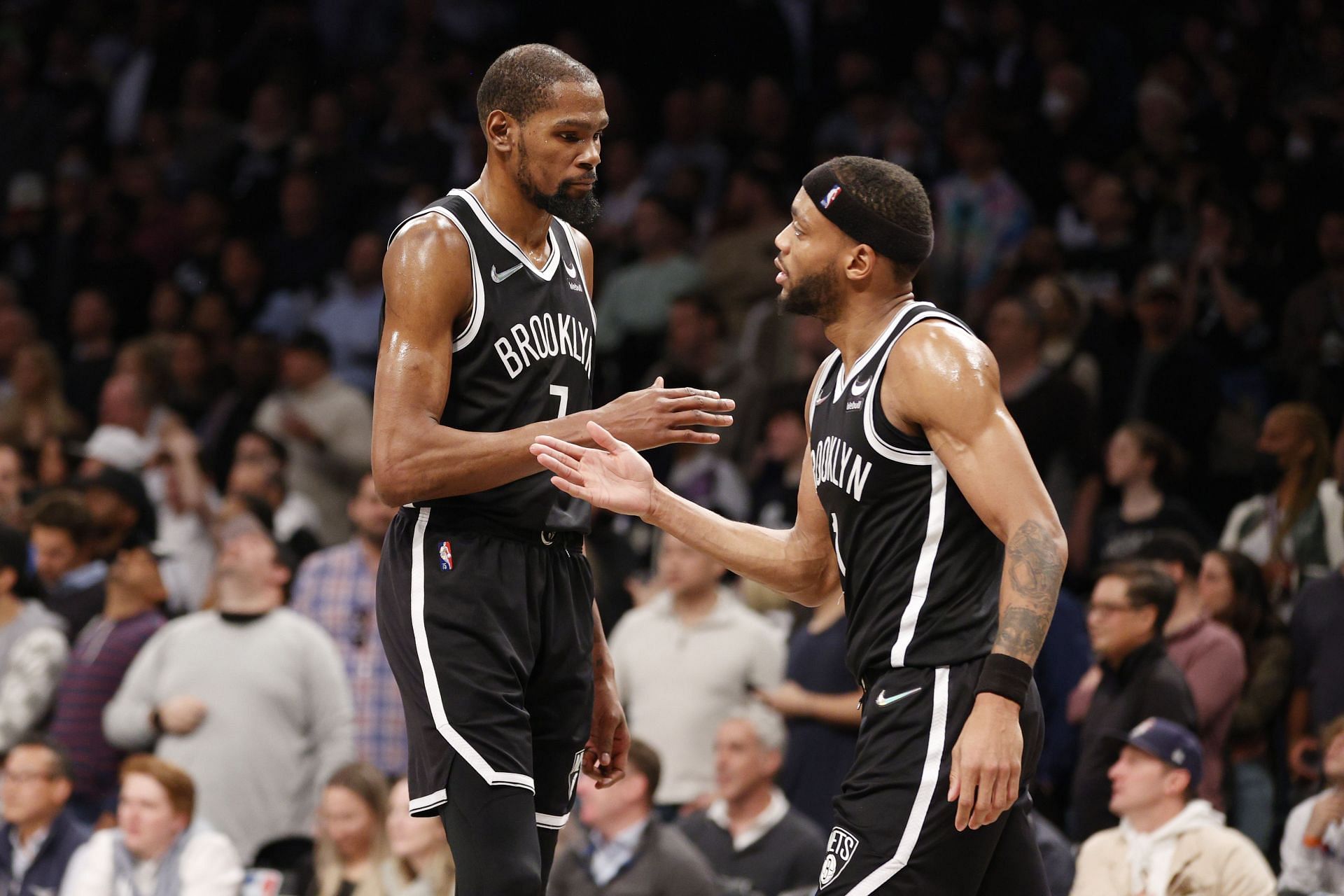 Kevin Durant high-fives Bruce Brown of the Brooklyn Nets.