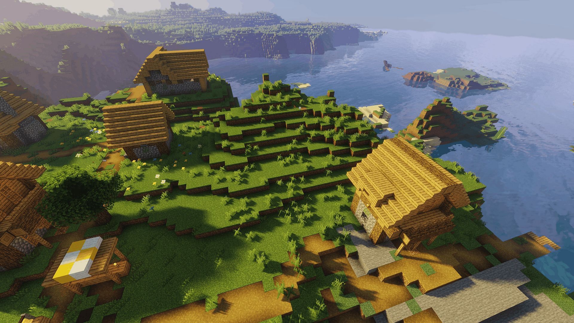 A plains village with Sildur's Vibrant Shader applied (Image via Minecraft)