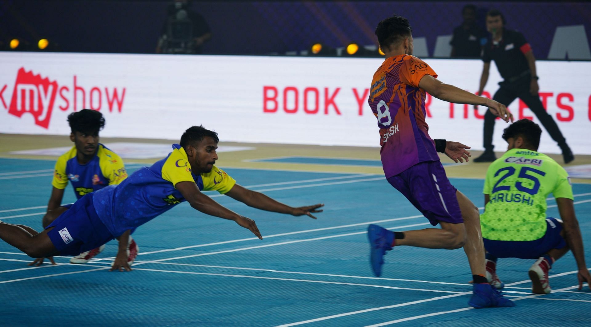 Abhijit Patil (second from left) puts in a sky dive during an Ultimate Kho Kho 2022 match.