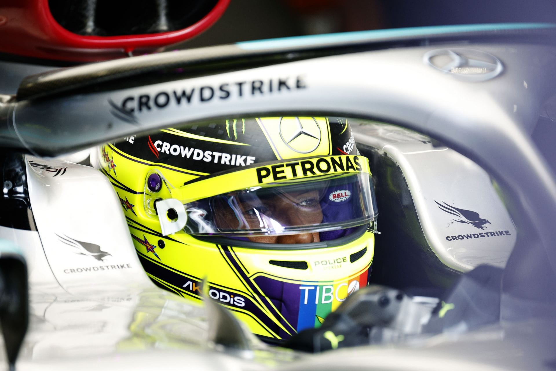 Why does Lewis Hamilton hold the steering wheel from the upper side?