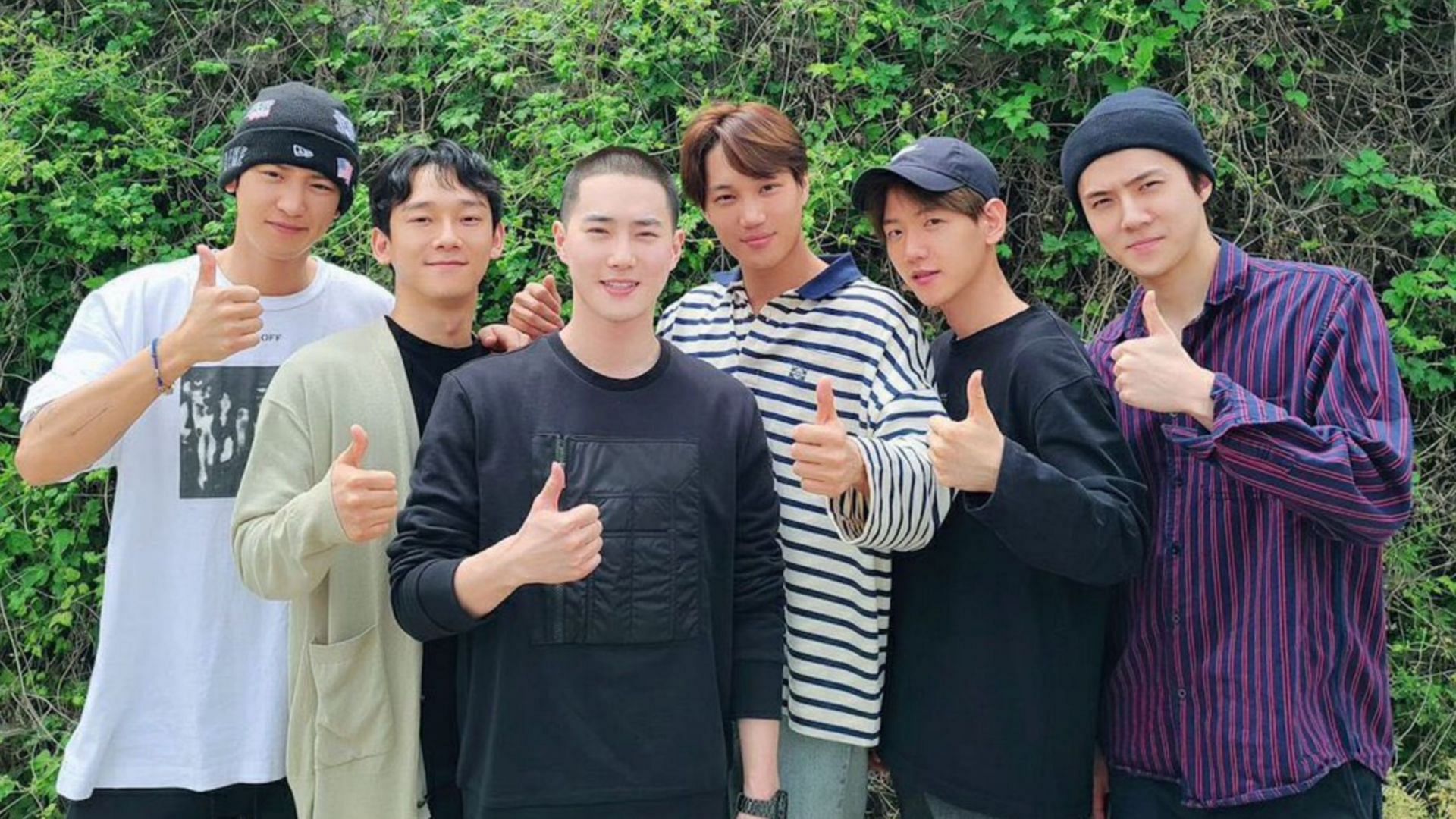 EXO members discharged their leader Suho (center in black) to the military on May 14, 2020. He returned in February 2022. (Image via twitter/@kyungsoouldier)