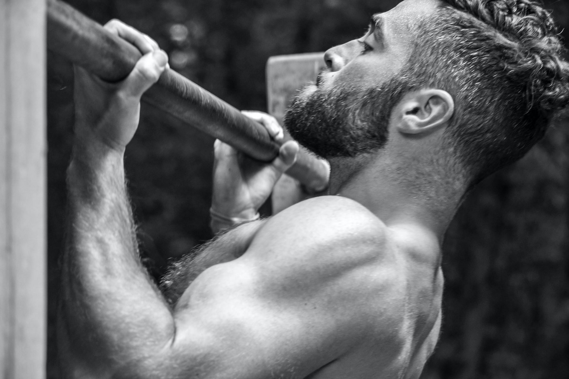 Butterfly pull-ups are really a more complex version of regular pull-ups. (Image via Unsplash/ J M)