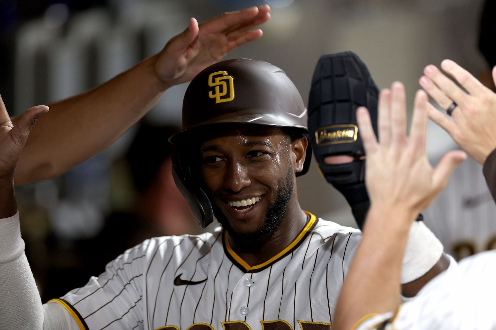 Jurickson Profar is congratulated in the dugout after scoring on an RBI against the San Francisco Giants at PETCO Park