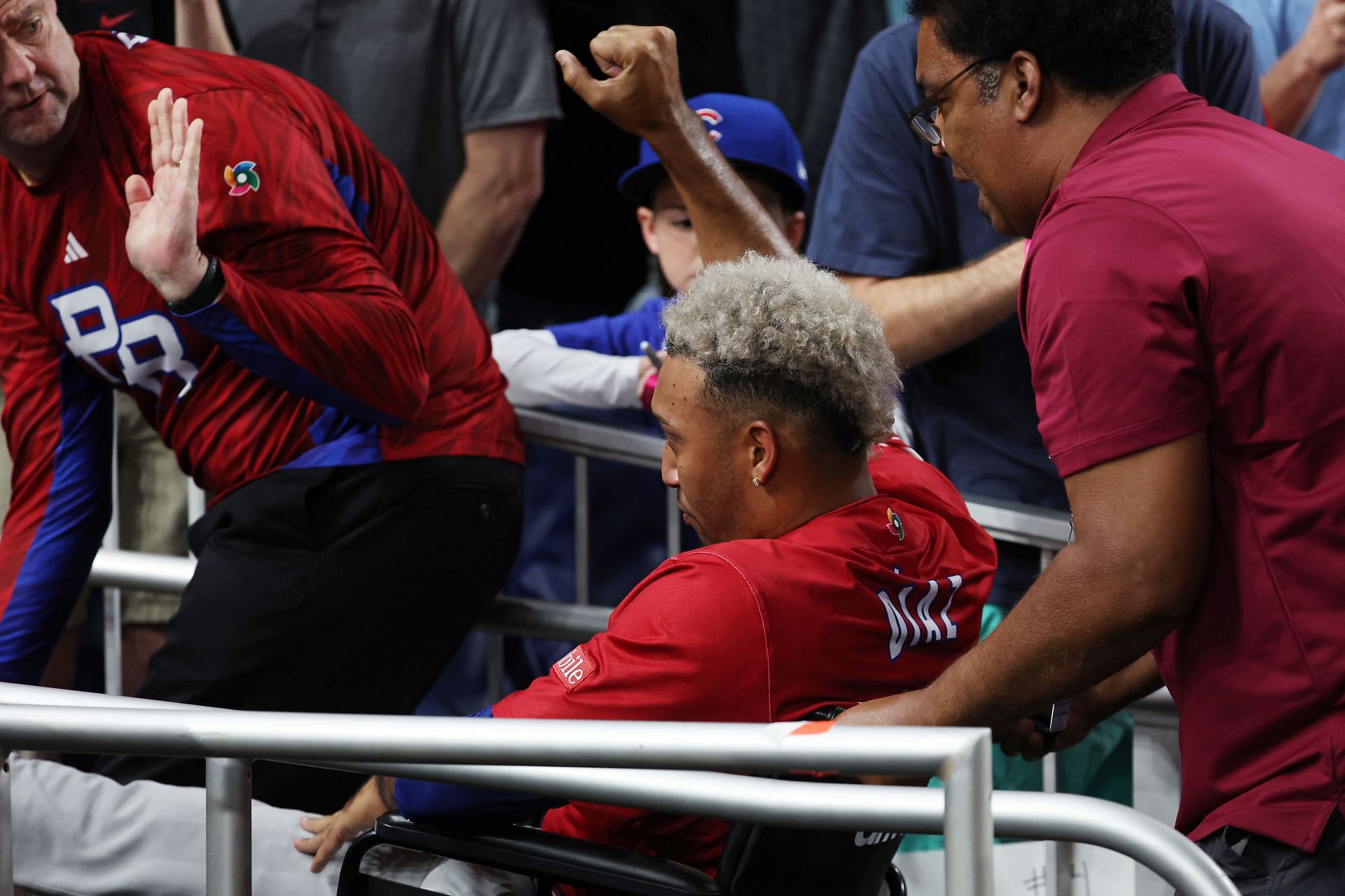 Edwin Diaz of Team Puerto Rico leaves the field in a wheelchair after sustaining an injury while celebrating a 5-2 win against Team Dominican Republic.