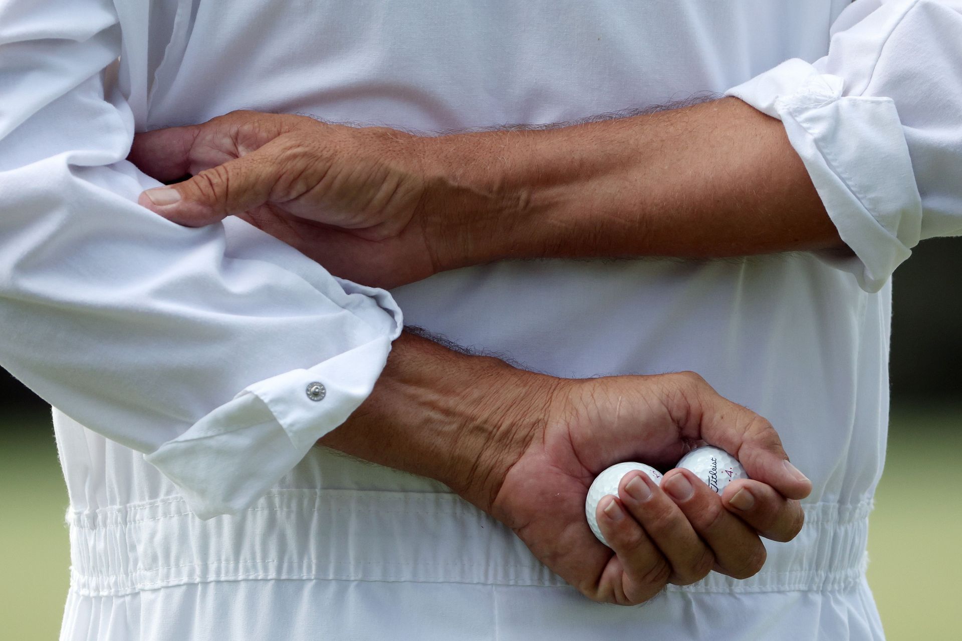 Why do caddies wear white boiler suits at the Masters?