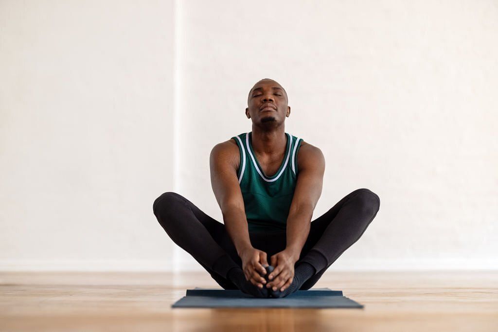 Join a yoga class or practice on your own to reap its benefits(Image via Getty Images)