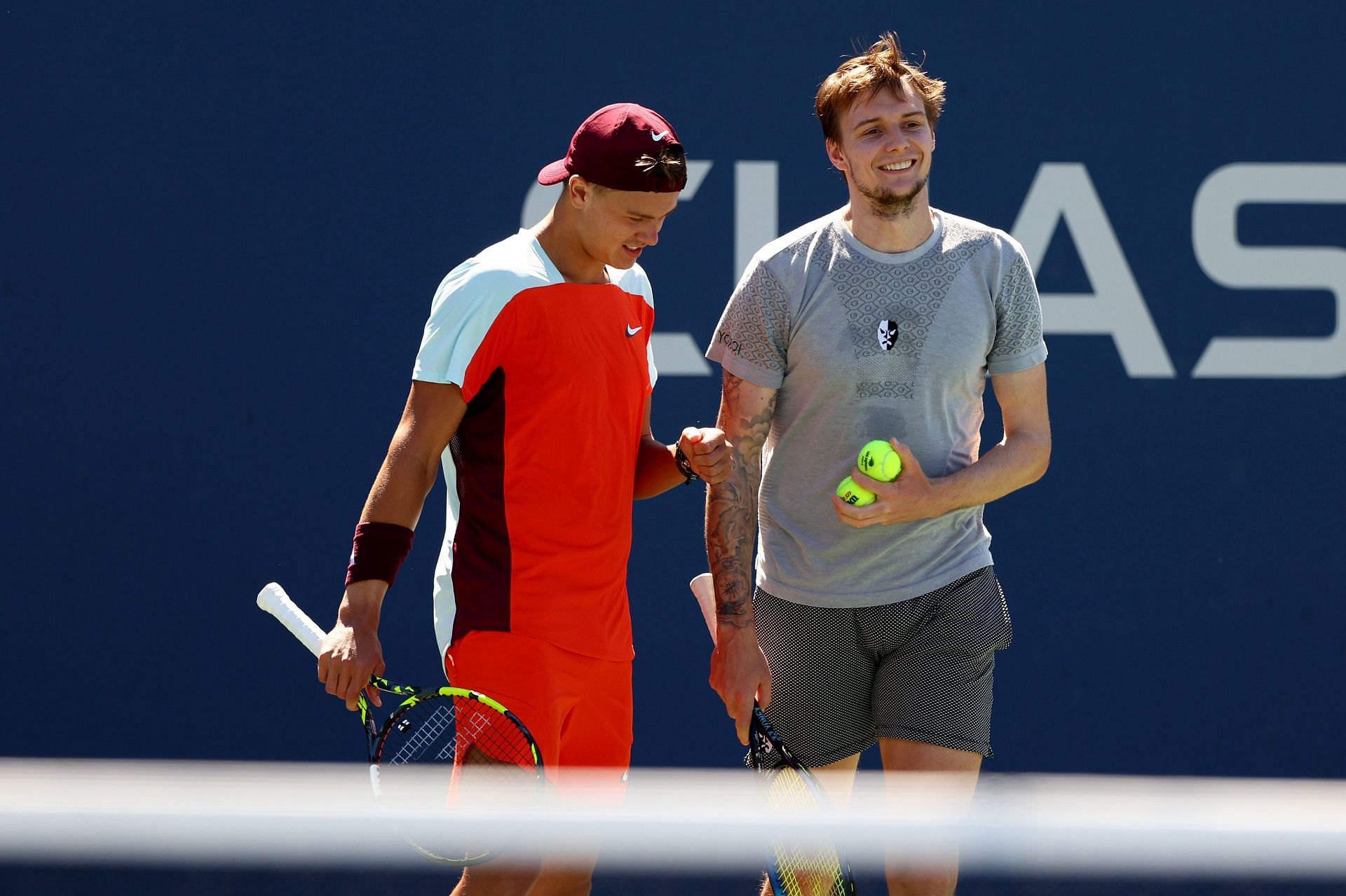 Holger Rune (L) and Alexander Bublik