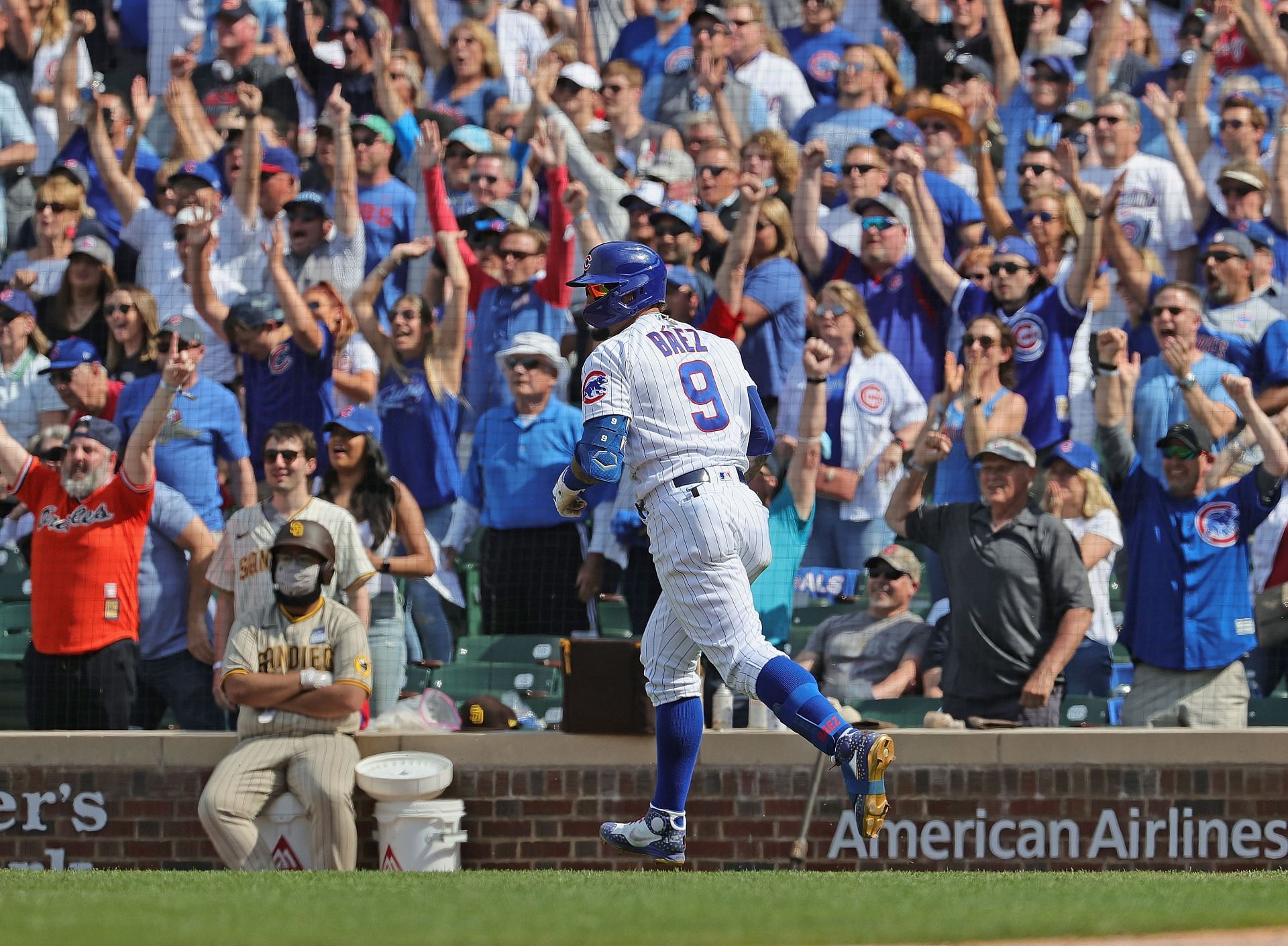 Fans cheer as Javier Baez of the Chicago Cubs runs the bases after hitting a solo home run against the San Diego Padres.