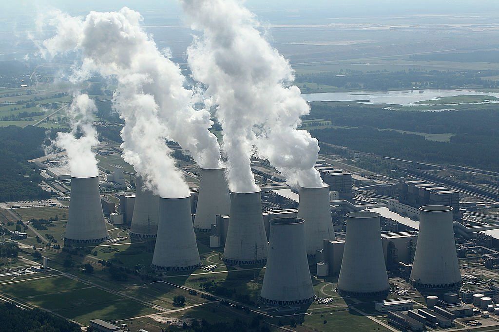 Steam rises from cooling towers at the Jaenschwalde coal-fired power plant(Image via Getty Images) 