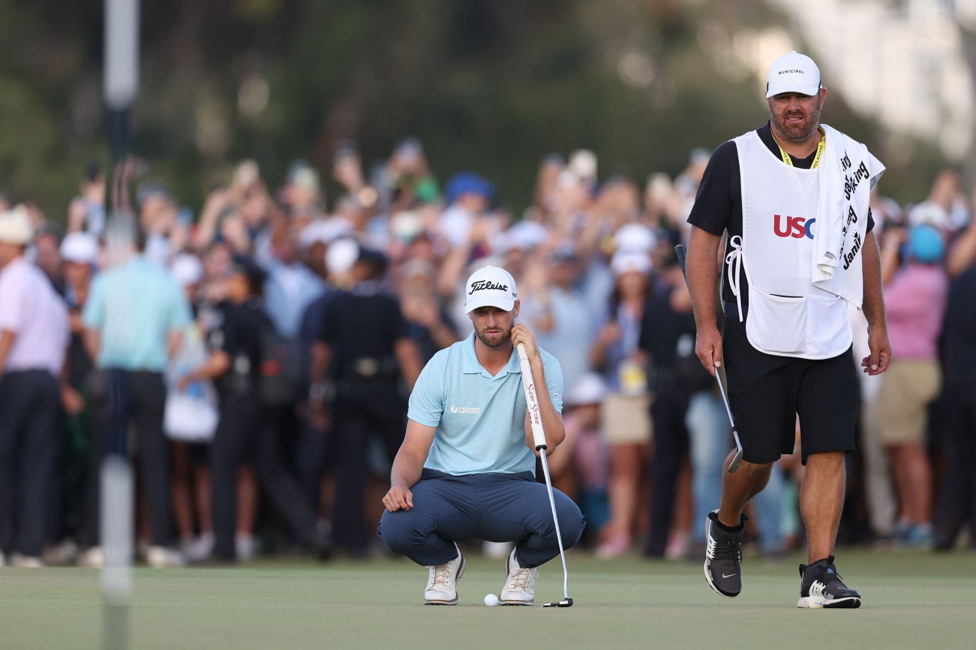 Xander Schauffele and Wyndham Clark's caddies engage in a lively