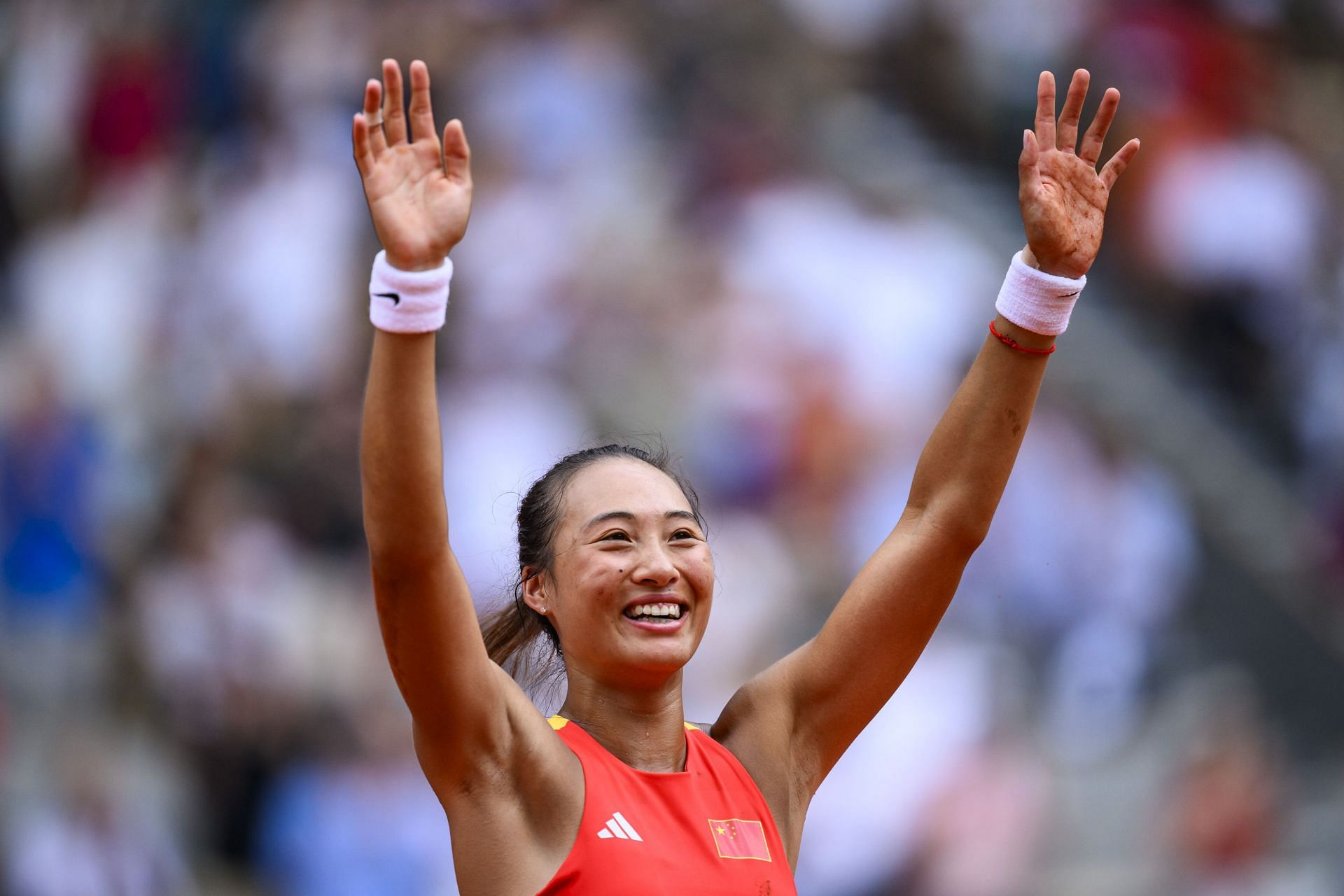 PICTURE: Zheng Qinwen falls to the ground in elation after scripting history as first Chinese tennis player to reach Olympic final at Paris 2024