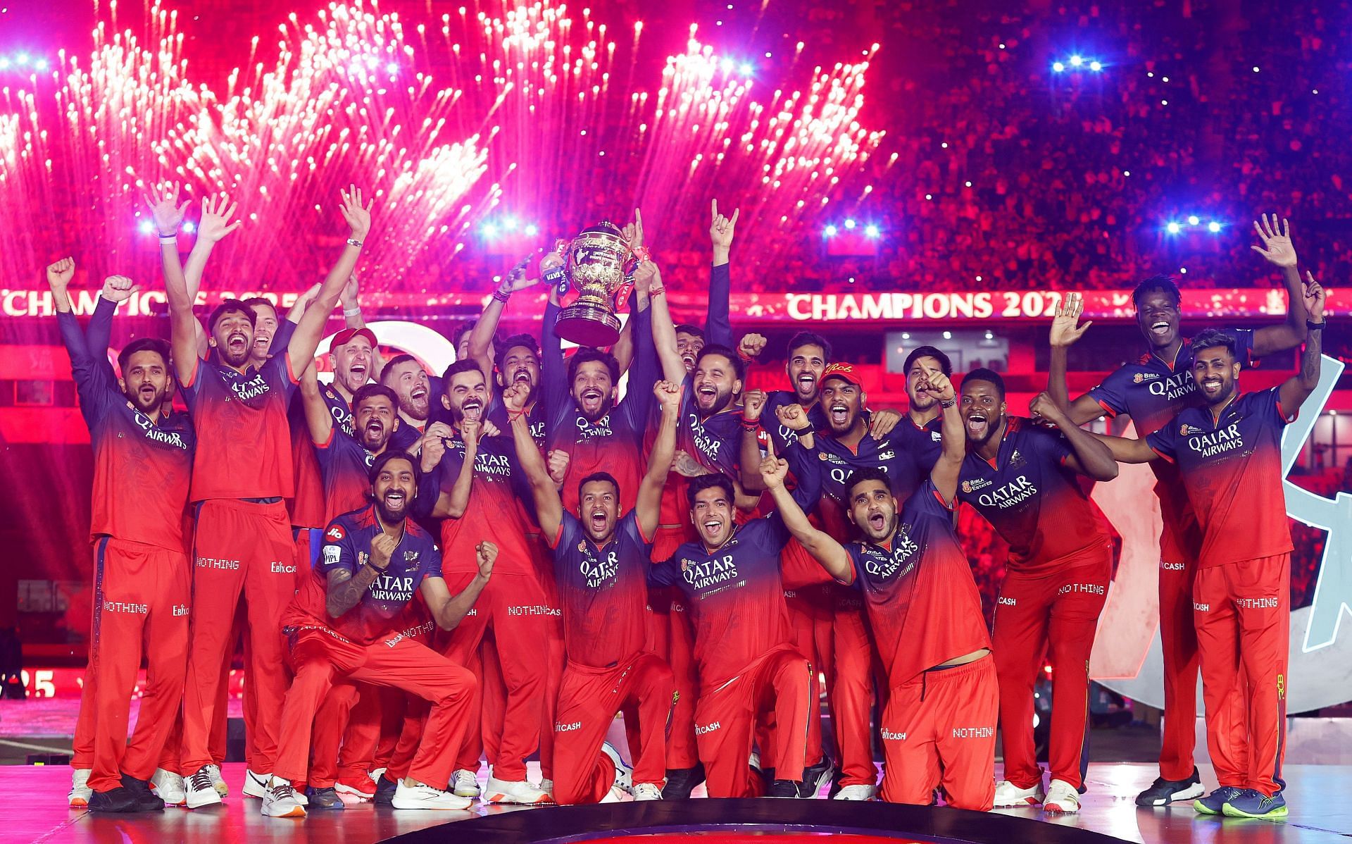 RCB captain Rajat Patidar lifts the IPL 2025 Trophy joyously with teammates on the podium [Watch]