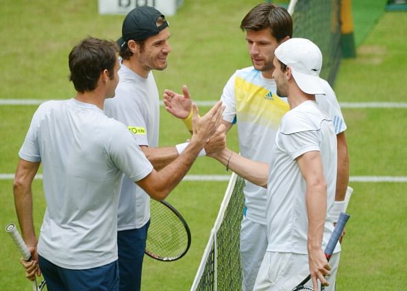 HALLE, GERMANY - JUNE 10: (L-R) Roger Federer of Switzerland, Tommy Haas of Germany, Jurgen Melzer of Austria and Philipp Petzschner of Germany shake hands after their first round doubles match during day one of the Gerry Weber Open at Gerry Weber Stadium