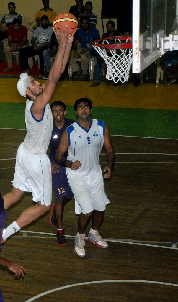 The Indian Overseas Bank Power Forward Amjyoth Singh is about dunk the ball in their match against Central Excise, Kochi. Photo Courtesy: Tournament Organisers.