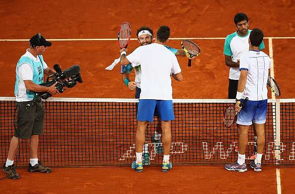 Jean-Julien Rojer of the Netherlands and Horia Tecau of Romania shake hands at the net after their straight sets victory against Rohan Bopanna of India and Florin Mergea of Romania in the mens doubles final during day nine of the Mutua Madrid Open