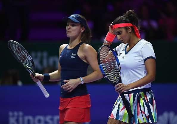 SINGAPORE - OCTOBER 29:  Sania Mirza (R) of India and Martina Hingis of Switzerland look dejected in their doubles semi-final against Elena Vesnina and Ekaterina Makarova of Russia during day 7 of the BNP Paribas WTA Finals Singapore at Singapore Sports Hub on October 29, 2016 in Singapore.  (Photo by Clive Brunskill/Getty Images)