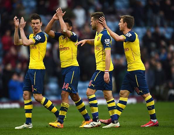 BURNLEY, ENGLAND - APRIL 11:  (L-R) Laurent Koscielny, Francis Coquelin, Aaron Ramsey Nacho Monreal of Arsenal applaud the fans after the Barclays Premier League match between Burnley and Arsenal at Turf Moor on April 11, 2015 in Burnley, England.  (Photo by Laurence Griffiths/Getty Images)