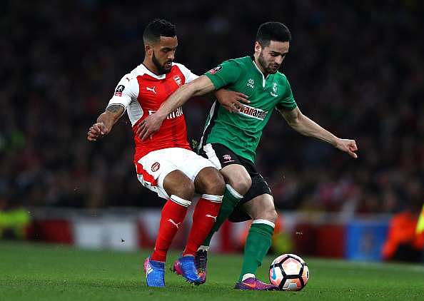 LONDON, ENGLAND - MARCH 11:  Samuel Habergham of Lincoln City battles with Theo Walcott of Arsenal during The Emirates FA Cup Quarter-Final match between Arsenal and Lincoln City at Emirates Stadium on March 11, 2017 in London, England.  (Photo by Ian Walton/Getty Images)