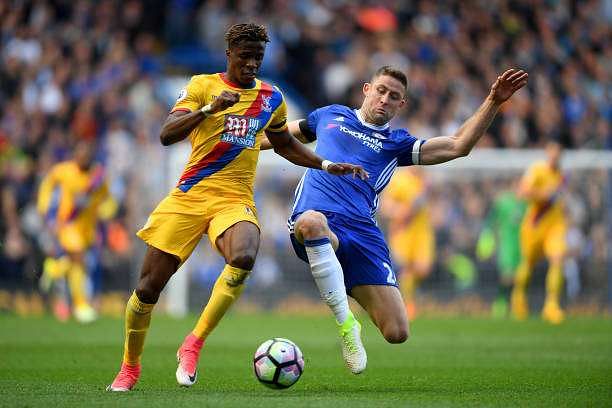 LONDON, ENGLAND - APRIL 01:  Wilfried Zaha of Crystal Palace (L) is tackled by Gary Cahill of Chelsea (R) during the Premier League match between Chelsea and Crystal Palace at Stamford Bridge on April 1, 2017 in London, England.  (Photo by Mike Hewitt/Getty Images)
